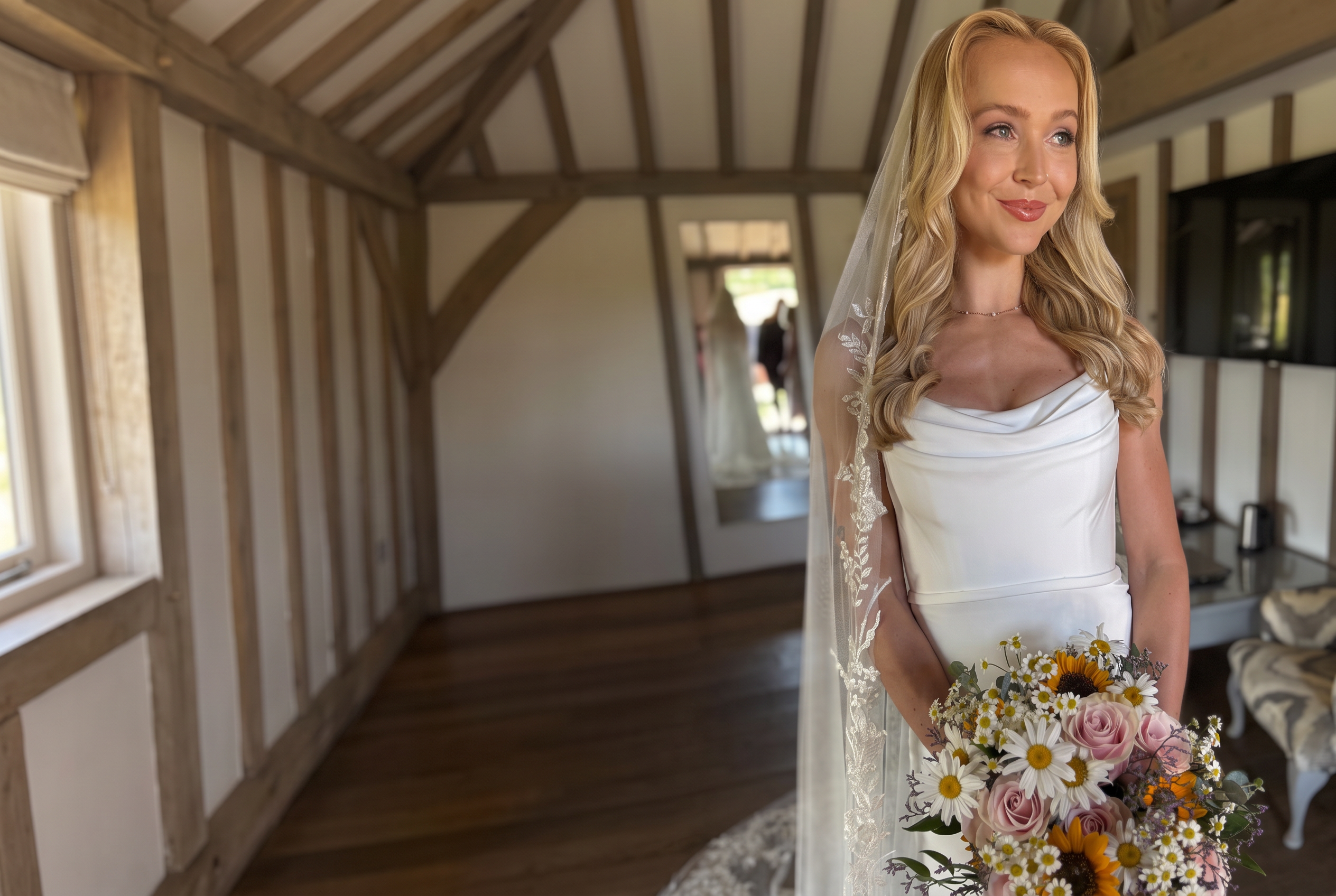 Bride wearing softly waved hair and natural makeup by Be Bridal